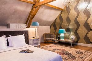 Un pat sau paturi într-o cameră la Château de l'Epinay