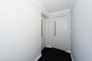 an empty hallway with white walls and a door at Beautiful Apartment near Bournemouth, Poole & Sandbanks in Poole