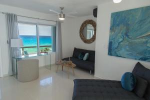 a living room with a couch and a table at Ocean View Three Bedroom, Three Story Penthouse by the Beach in Cancún
