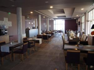a dining room with tables and chairs in a restaurant at A-Apartment in Krasnovo