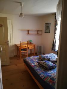 a bedroom with a bed and a dining room table at Mini-Hôtel de Camps in Camps-sur-lʼAgly