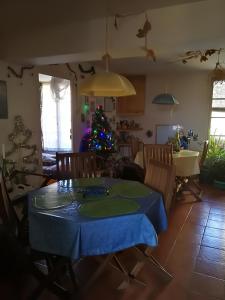 a dining room with a table and a christmas tree at Mini-Hôtel de Camps in Camps-sur-lʼAgly