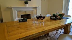two glasses of wine sitting on a wooden table at Pavilion House in Exeter