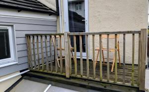 a porch with a fence next to a house at Pavilion House in Exeter