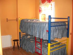 two bunk beds in a room with a window at Apartamentos Sierra Nevada Welcome in Sierra Nevada