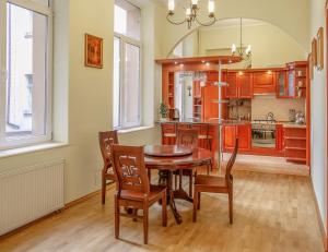 cocina con mesa de comedor y sillas en Grand Lviv Apartment I (1 of 3) en Leópolis