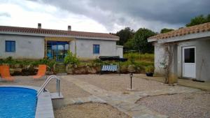 a house with a swimming pool in front of a house at Ferienappartement Angelika in Arzachena