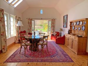 Spacious cottage - walk to Crieff في كريف: غرفة طعام مع طاولة وكراسي في غرفة