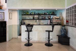 a kitchen area with a sink, shelves, and cabinets at Albergo Marina in Sestri Levante