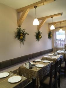 ein Esszimmer mit Tischen, Stühlen und Lichtern in der Unterkunft HOTEL BOBROvski in Jassinja