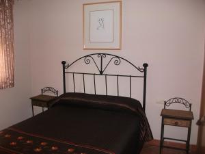 a bedroom with a black bed and two night stands at Apartamentos Sierra Nevada Welcome in Sierra Nevada