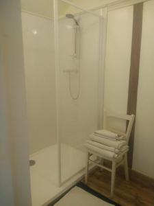 a bathroom with a shower with a chair next to a shower at Lisieux House on Lough Neagh in Aghalee