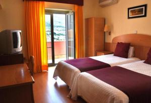Cama ou camas em um quarto em Hotel Solneve