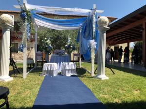 a blue tent with a table and chairs under it at Tenuta Lanza Il Mulino in Acquaviva Platani