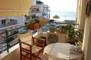 a balcony with a table and chairs and a view of the ocean at Cosy Home Boutique Apartment in Perea