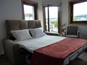 a large bed in a room with a window at Casa da Ponte in Mirandela