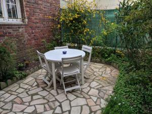 a table and chairs sitting on a stone patio at Maison de Pêcheurs en centre ville in Deauville