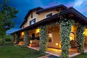 a house covered in ivy at night at Hotel Villa Rizzo Resort and Spa in San Cipriano Picentino