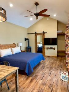 a bedroom with a bed and a ceiling fan at Baycrest Lodge in Homer