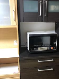 a microwave oven sitting on top of a counter at STAY Sakura in Bibai