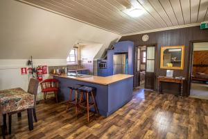 a kitchen with a blue island in a room at Gold Mine Guest House and Cafe in Nundle