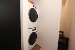 two washer and dryer in a corner of a room at Condo "Imagine" - stationnement privé inclus in Quebec City