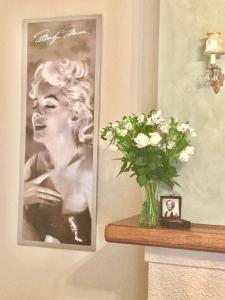 a painting of a vase with flowers on a wall at Jones On Wilson Boutique B&B in Burnie