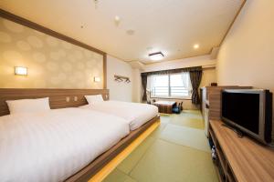Postel nebo postele na pokoji v ubytování Hotel Green Plaza Hakone
