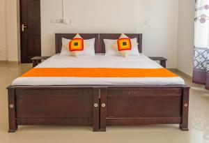a bedroom with a bed with two lamps on it at Harry Inn in Negombo +18 photos