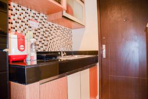a kitchen with a sink and a counter top at Spacious 2BR GP Plaza Apartment By Travelio in Jakarta