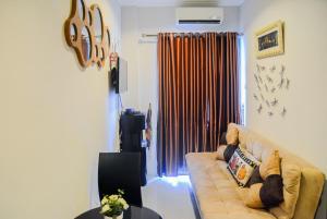a living room with a couch and a window at Spacious 2BR GP Plaza Apartment By Travelio in Jakarta