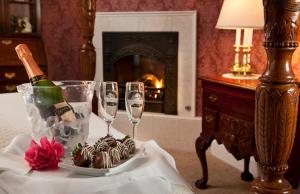 a table with two wine glasses and a bottle of champagne at Churchill Manor in Napa