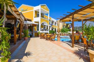 a resort with a pool and tables and chairs at Vanessa Hotel in Kalamaki