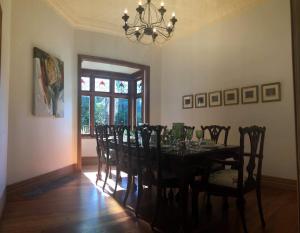 a dining room with a table with chairs and a chandelier at 21morero in Taumarunui