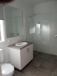 a bathroom with a toilet and a sink and a shower at 123 Wilson - Arapiles in Horsham