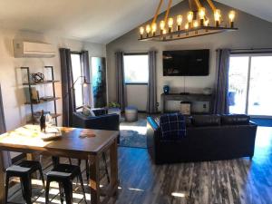 a living room with a couch and a table at Papillon Cellars - The Loft in Mariposa