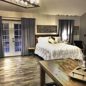 a bedroom with a bed and a table in it at Papillon Cellars - The Loft in Mariposa