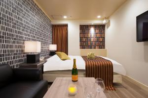Postel nebo postele na pokoji v ubytování HOTEL U's 香櫨園