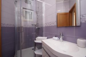a bathroom with a sink and a shower at Apartments Mirna in Korčula +81 photos