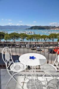 a table and chairs on a balcony with a view of a harbor at The Best View Of The Sea in Lerici