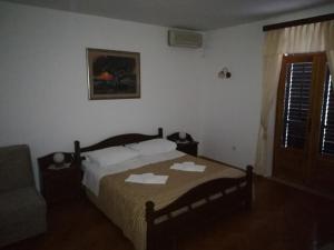 a bedroom with a bed with two white towels on it at Villa Kukuljica in Zaton