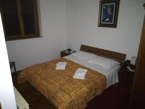 a bedroom with a bed with two towels on it at Villa Kukuljica in Zaton