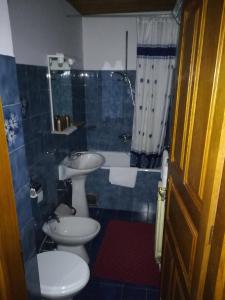 a bathroom with two toilets and a sink and a tub at Villa Kukuljica in Zaton