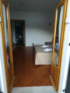 a bedroom with a bed and a mirror in a room at Villa Kukuljica in Zaton