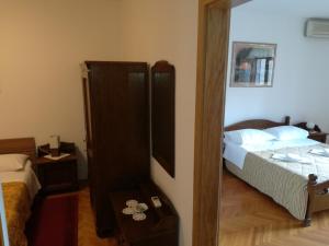 a bedroom with a bed and a mirror at Villa Kukuljica in Zaton