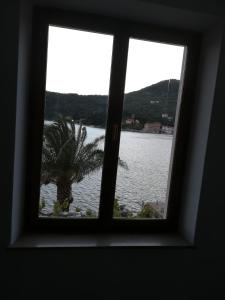 a window in a room with a view of the water at Villa Kukuljica in Zaton
