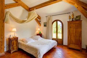 a bedroom with a white bed and a window at La Ferme Rose-Hôtel de Charme in Moustiers-Sainte-Marie +32 photos