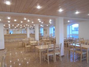 a dining room with wooden tables and chairs at Park-Hotel Diyevo Gorodishche in Yaroslavl