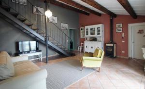 a living room with a couch and a staircase at Casa S.Paolo in Rimini