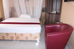 Postel nebo postele na pokoji v ubytování Eureka Place Hotel Kampala